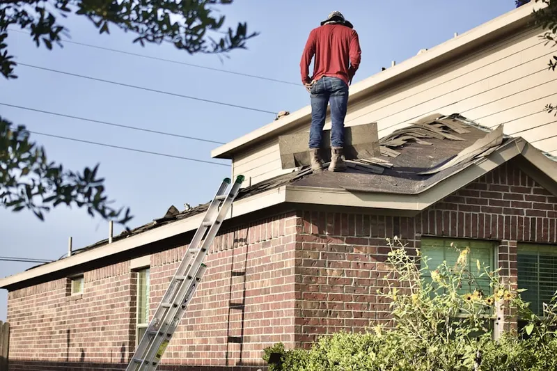 Professional roofer working on a residential roof in Nassau Farms